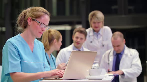 Nurse using laptop in conference room