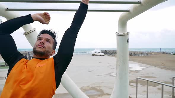 Man training at the beach outdoor gym