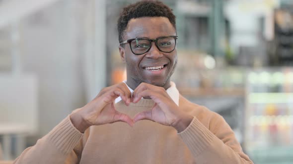 Creative African Man Showing Heart Shape By Hands