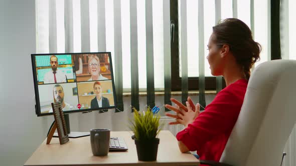 Woman Talking with Colleagues on Webcam