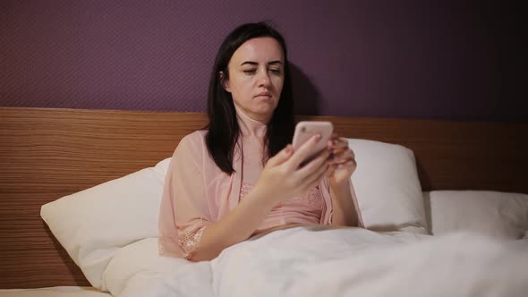 Wife in Bed Texting a Message to Her Husband Who Didn't Come Home
