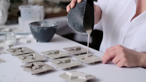 Woman Craftswoman Pours the Plaster Mixture Into Silicone Molds