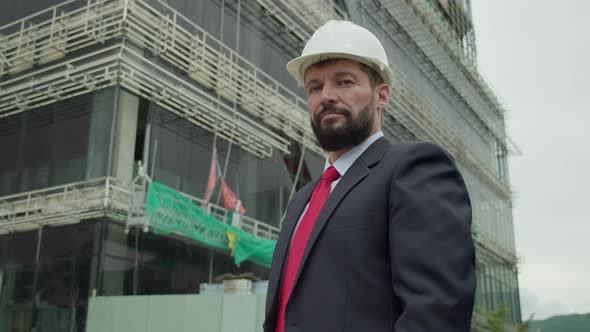 Portrait Senior Engineer Scientist and Developer at a Construction Site Wearing a Protective Helmet