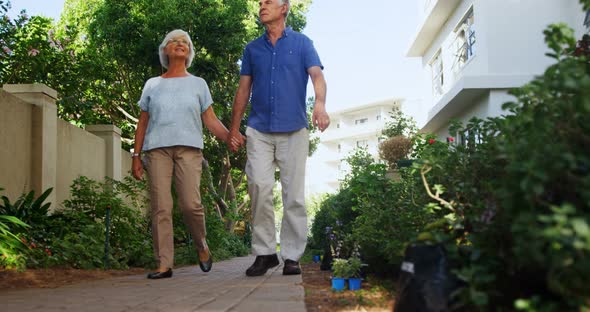 Senior couple walking in the garden