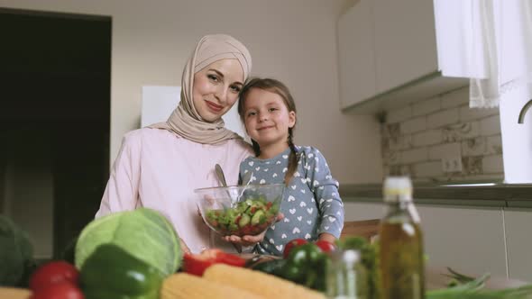 Head Shot Portrait Smiling Arabian Muslim Woman with Caucasian Daughter Cooking Salad Together