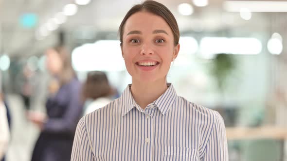 Portrait of Appreciative Young Woman Saying Yes By Shaking Head