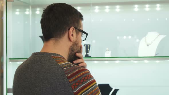 Bearded Mature Man Choosing Jewelry Present at the Shopping Mall
