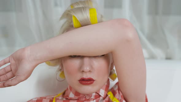 Portrait of a Young Housewife in Hair Curlers