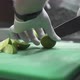 Chef in Gloves Cuts Fresh Lime Into Slices with Knife - VideoHive Item for Sale