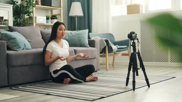 Joyful Asian Woman Popular Blogger Is Recording Video Using Professional Camera Talking Then Showing