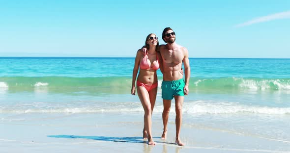 Young couple walking on beach