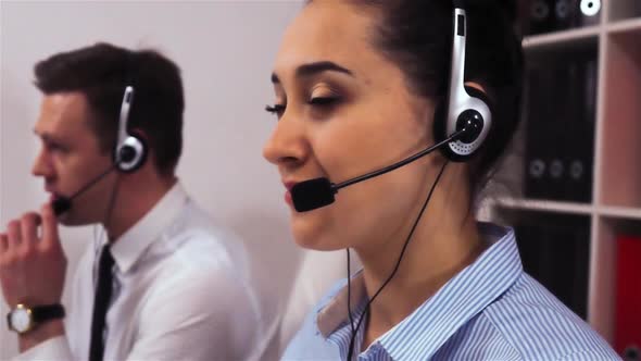 A Team of Call Centre Executives Wearing Headset Busy on a Phone with Customers