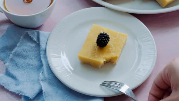 Piece of tasty homemade lemon pie with blackberry on plate