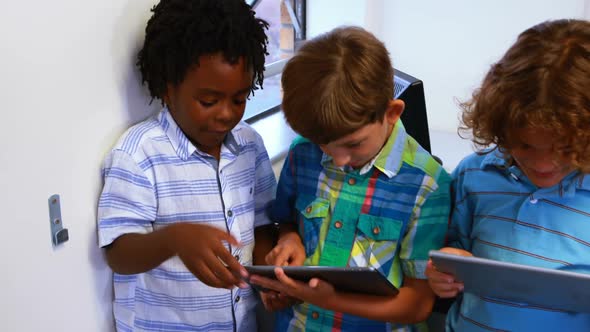 School kids using digital tablet in classroom alt