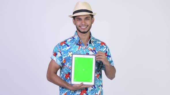 Young Happy Bearded Indian Tourist Man Showing Digital Tablet