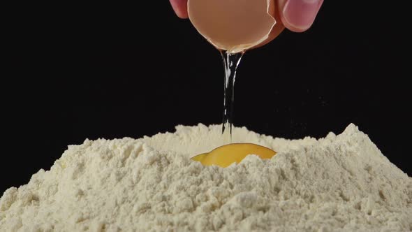 Hands Throw An Egg On A Pile Of Flour