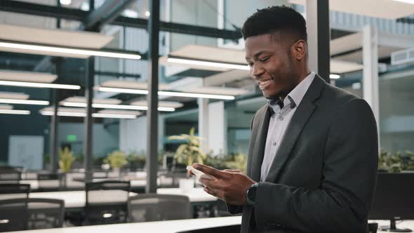 Happy Millennial Man African American Male Businessman Employee Adult Guy Hold Cellphone Chat in