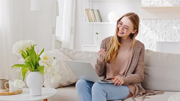 Happy Successful Woman Blonde Caucasian Millennial Girl with Computer Laptop Reads Good News