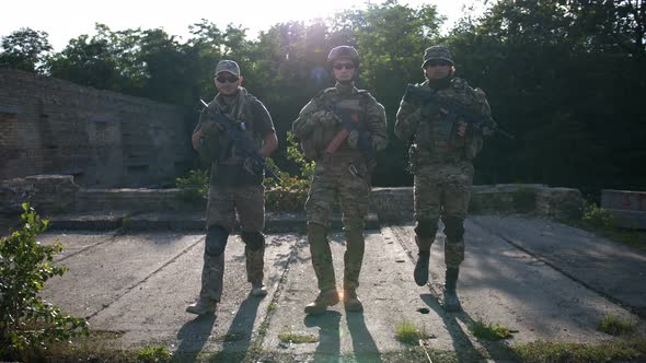 Soldiers in Full Gear Patrolling the Area at Sunset