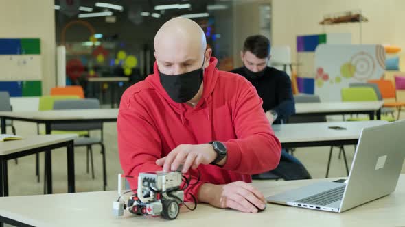 Robotics Teacher Who Teaches an Online Course for His Students Using a Computer