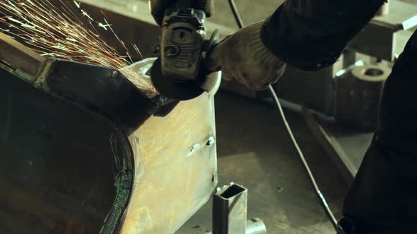 Worker Using Industrial Grinder