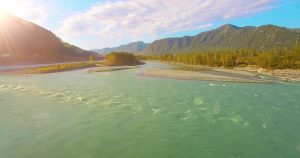 Low Altitude Flight Over Fresh Fast Mountain River with Rocks at Sunny Summer Morning