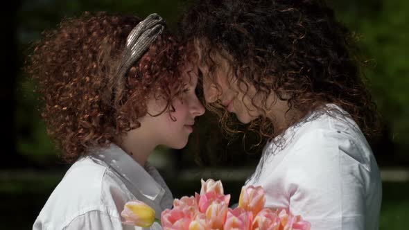 Portrait of a Mother and Daughter of a Teenager Looking at Each Other with Love and Tenderness