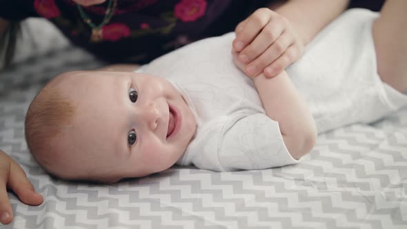 Infant Baby Smiling From Sister Kiss