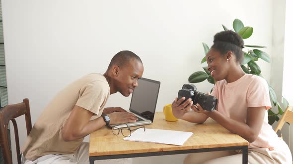 Cheerful Woman Shows Photo on Camera To Her Husband