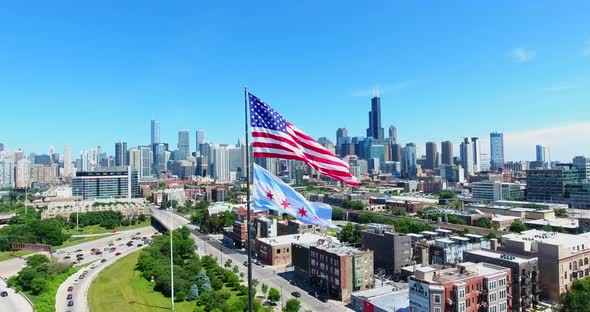 Aerial Drone Shot of Chicago Downtown Above the Highway with American Flag