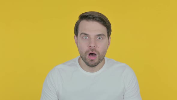 Shocked Young Man on Yellow Background