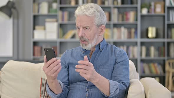 Old Man Reacting to Failure on Smartphone