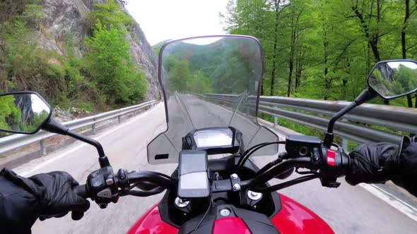 Motorcyclist on Motorbike Rides on a Beautiful Landscape Mountain Road in Italy