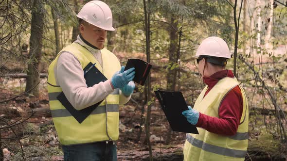 Man Woman Environmentalists Document Offense  Forest Pollution and Issue Fine