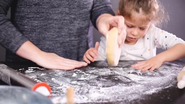 Mother and daughter baking sugar skull cookies for Dia de los Muertos holiday.