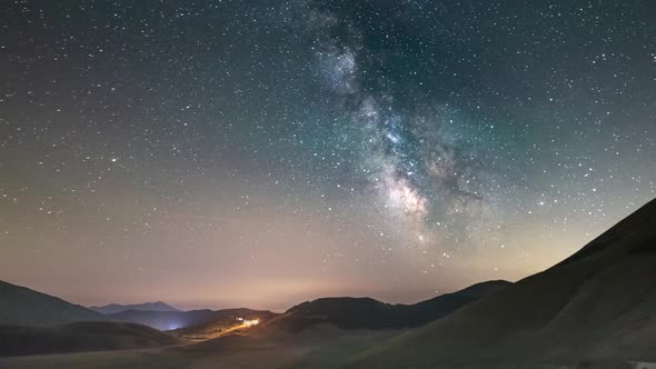 Time lapse: night sky over Castelluccio di Norcia highlands, Italy. The Milky Way galaxy and stars a