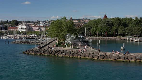 Aerial of people relaxing on pier at lake Geneva near the city of Lausanne, Switzerland