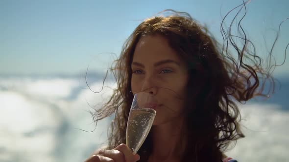 Woman on the Yacht Drinks Champagne and Enjoys Her Vacation While Sailing