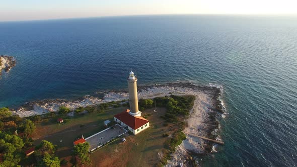 Flying over lighthouse, Croatia at sunset