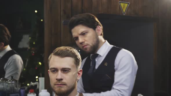 Professional Barber Working Burning Fire Hair Treatment on His Client