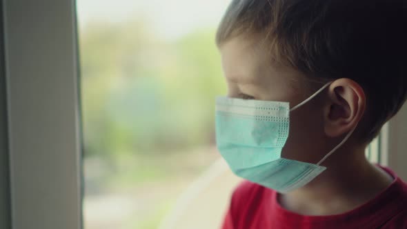 Sad Illness Child on Home Quarantine. Boy and His Teddy Bear Both in Protective Medical Masks Sits