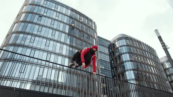 Parkour Man Jumping over Railings and Running in the City