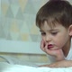 a Seven Year Old Boy Reads a Book in His Bed Before Going To Bed - VideoHive Item for Sale