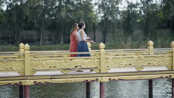 Female Tourists Strolling On The Bridge Of Ancient Siam Park In Bangkok Thailand