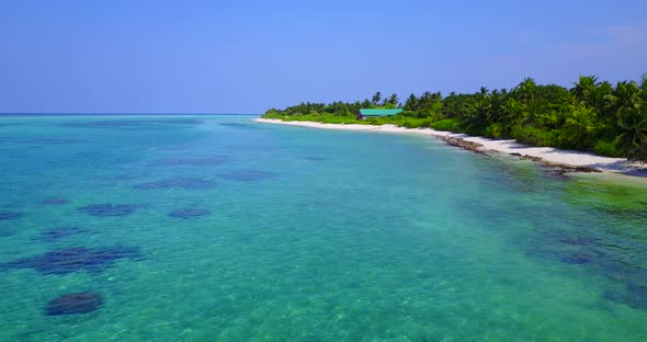 Daytime aerial travel shot of a sunshine white sandy paradise beach and blue sea background in vibra