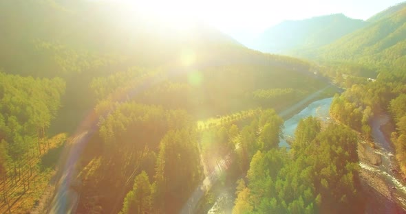 Low Altitude Flight Over Fresh Fast Mountain River with Rocks at Sunny Summer Morning.