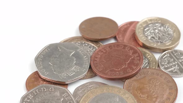 UK Currency pounds coins rotating close up footage against the white background