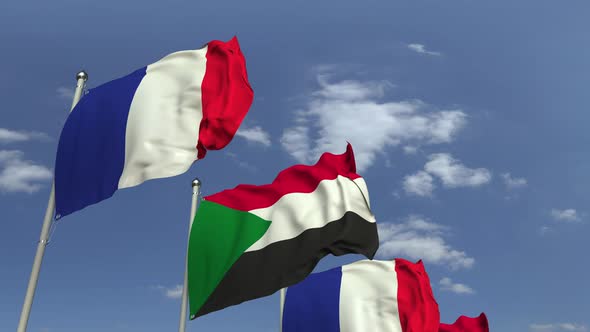 Waving Flags of Sudan and France on Sky Background alt