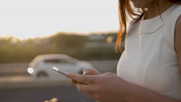 Cropped Shot of Young Woman Using Smartphone