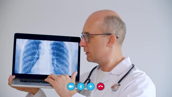 Doctor Using Laptop with X-ray Image of Lungs During Video Chat